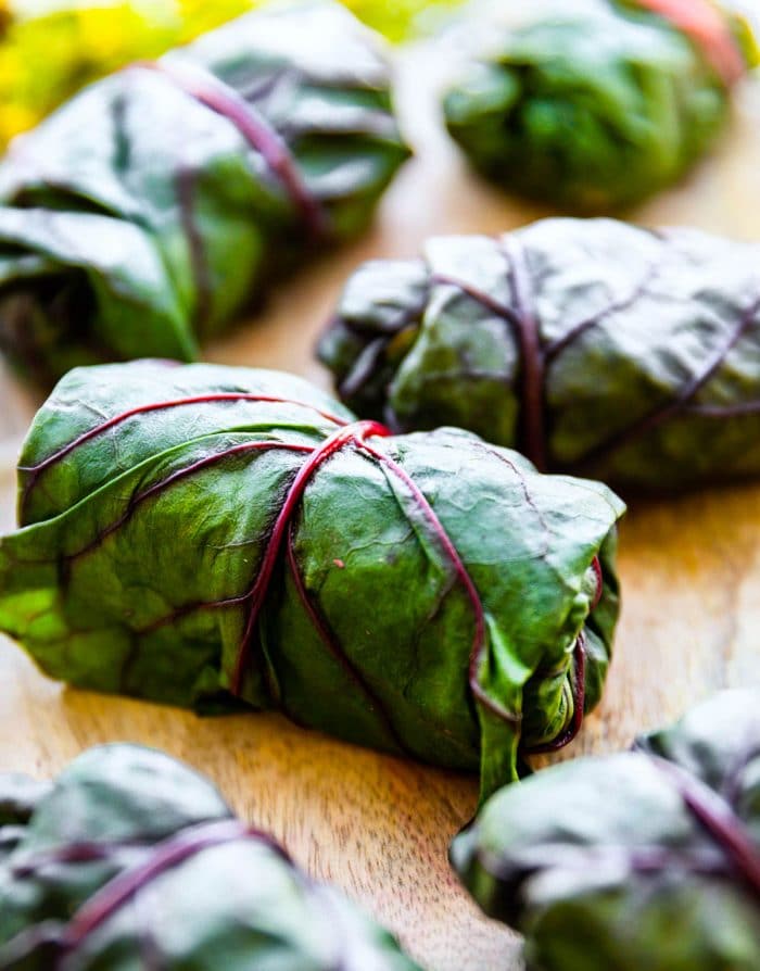 rainbow chard leaves rolled up with salad inside to make vegan wraps