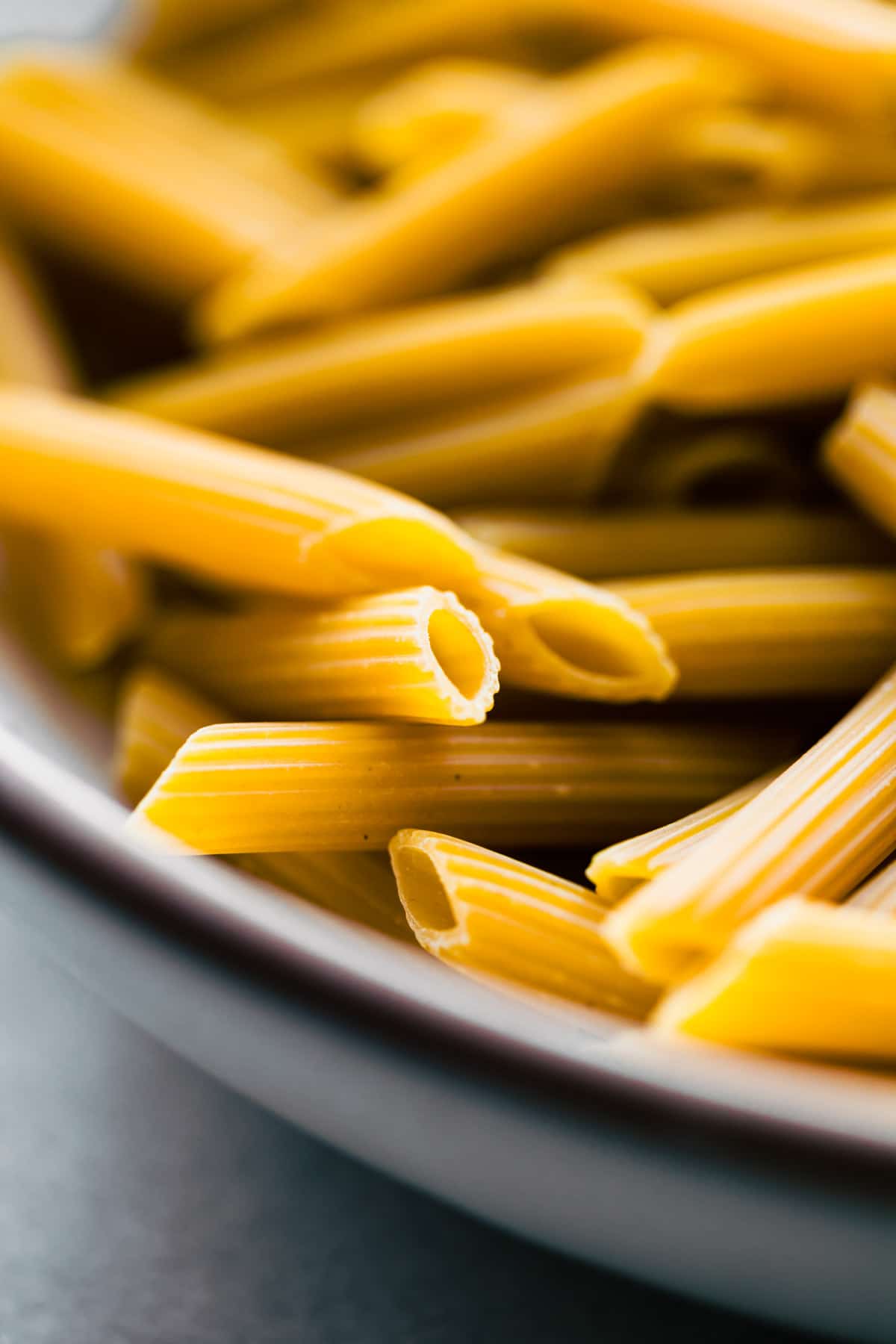 extreme close up photo of uncooked penne noodles