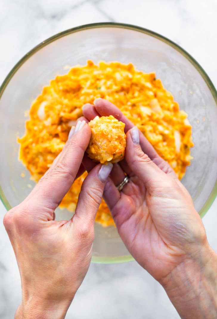 two hands forming a sweet potato tot to bake