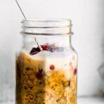 side view: jar of pumpkin overnight oats with vegan condensed milk on top. Spoon in the jar