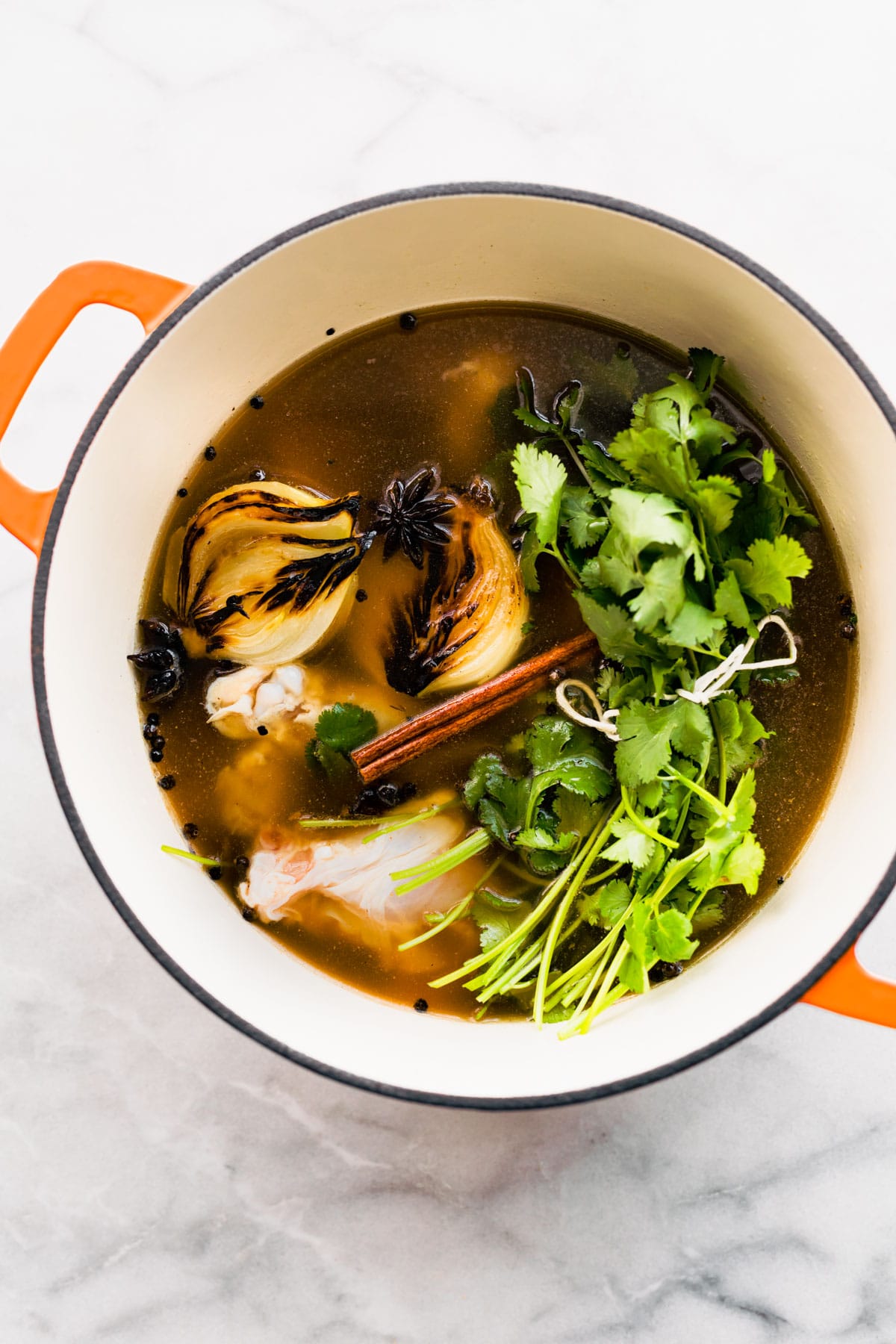 A pot of gluten free chicken pho ingredients simmering.