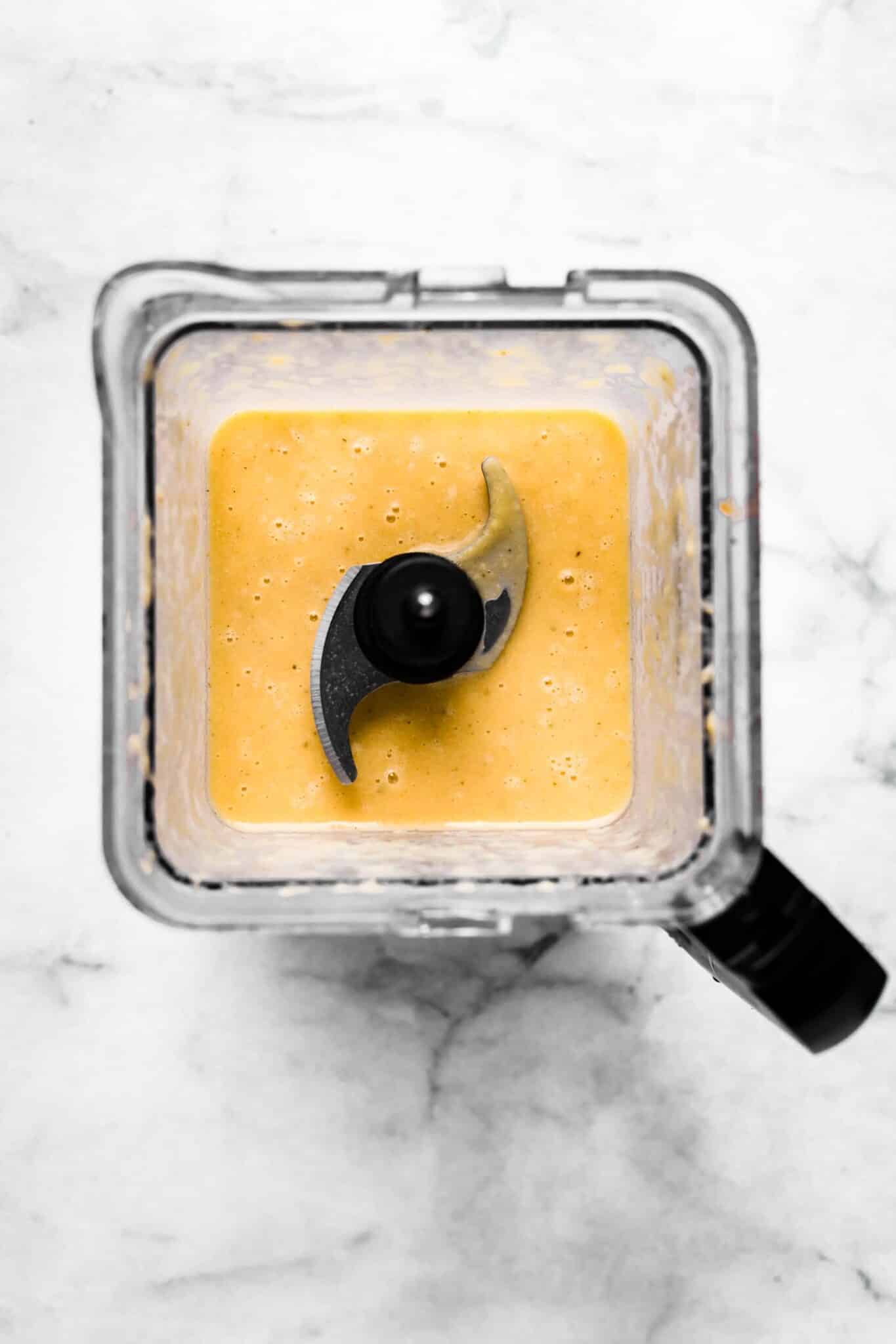Overhead photo of a blender with pureed cauliflower soup.