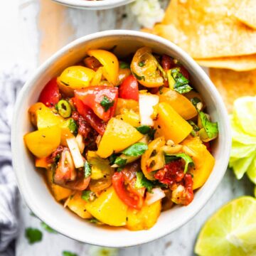 peach salsa with chipotle in cereamic bowl