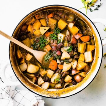 An overhead photo of a Dutch oven of gluten-free beef stew with a text overlay for pinterest.