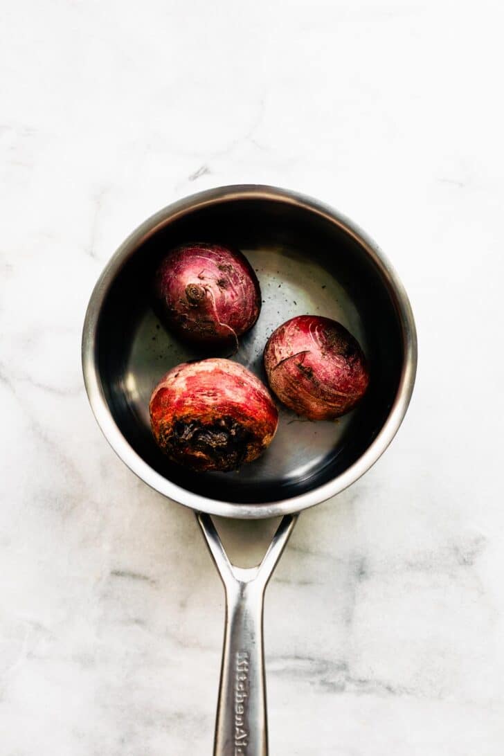 3 raw beets in a pot with water