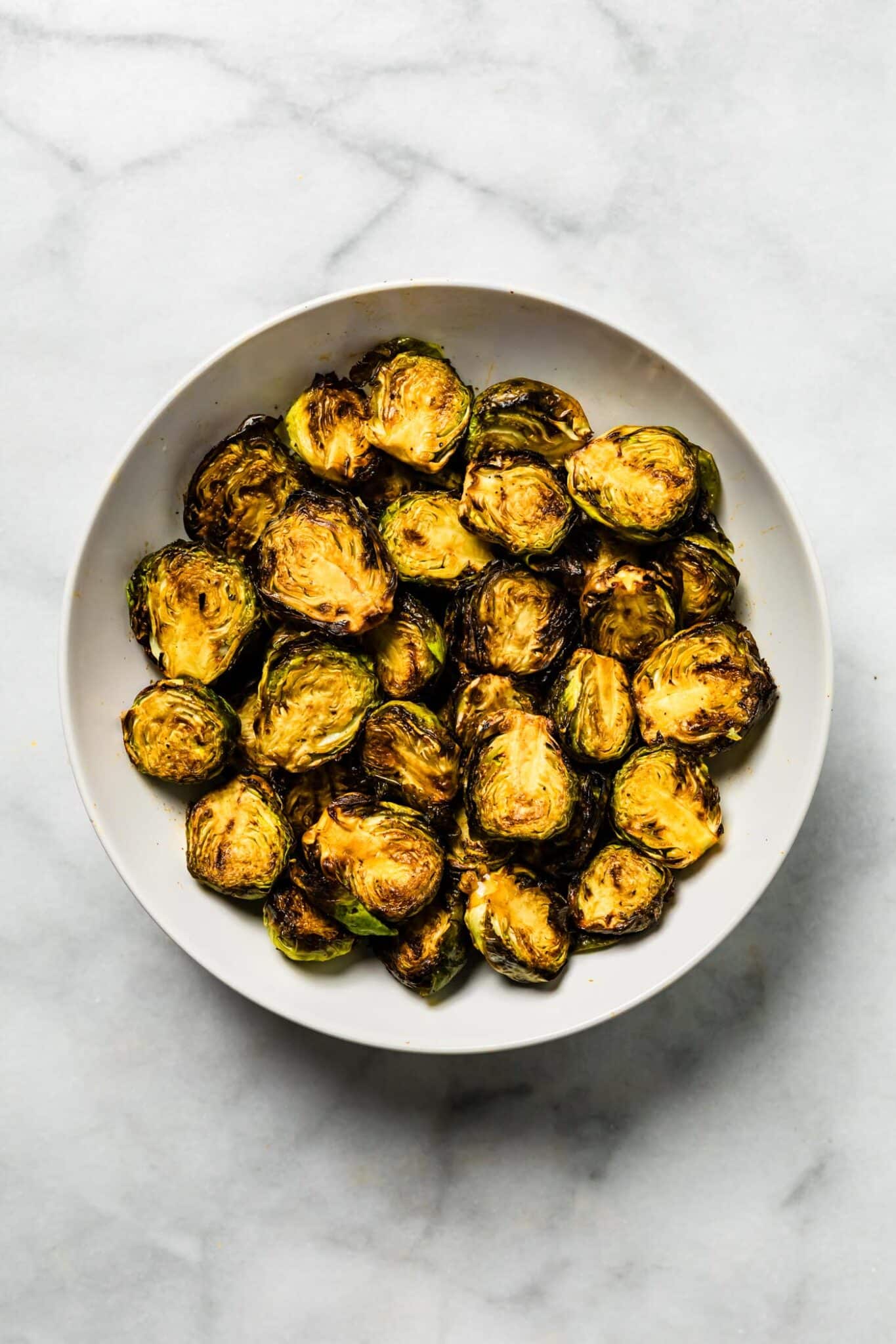 golden and caramelized Air fryer Brussels sprouts in white bowl
