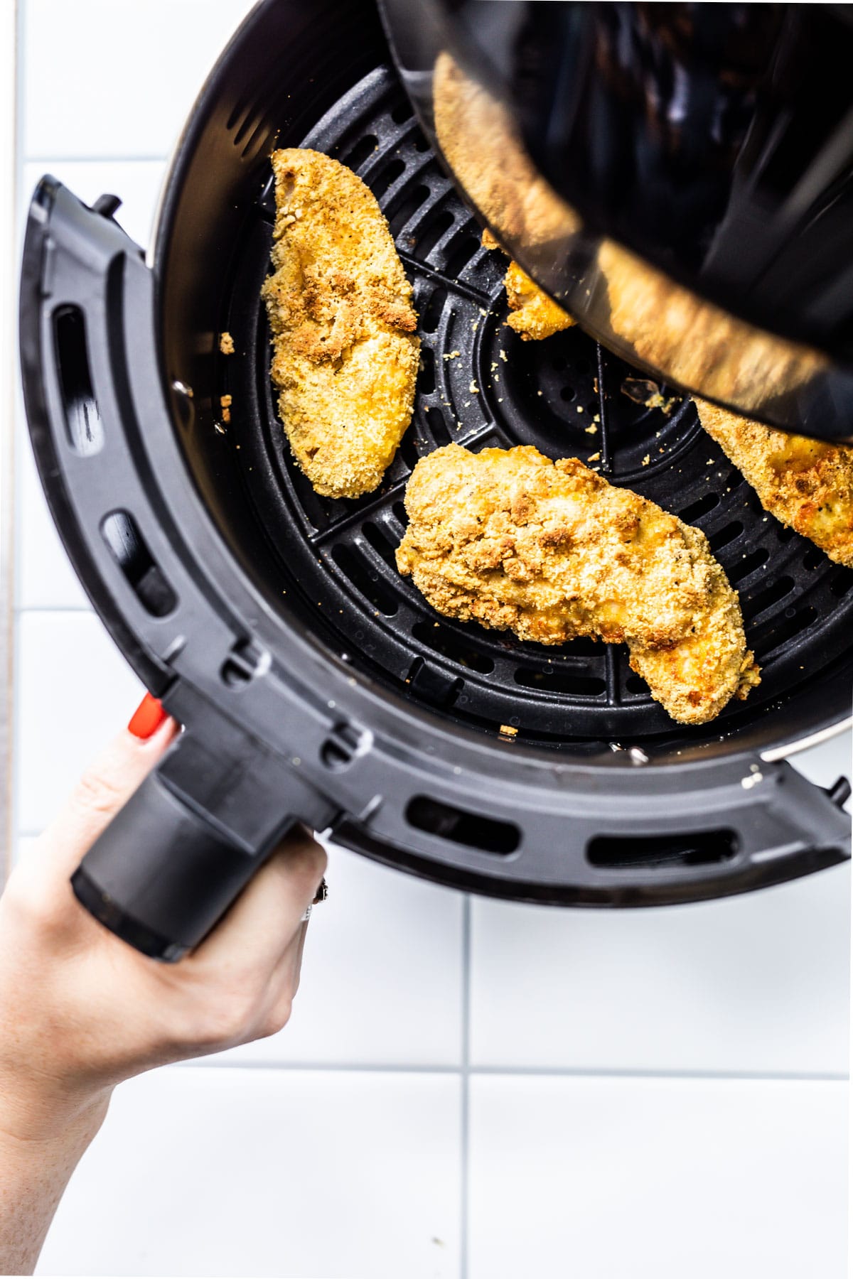 air fryer chicken tenders in an air fryer basket