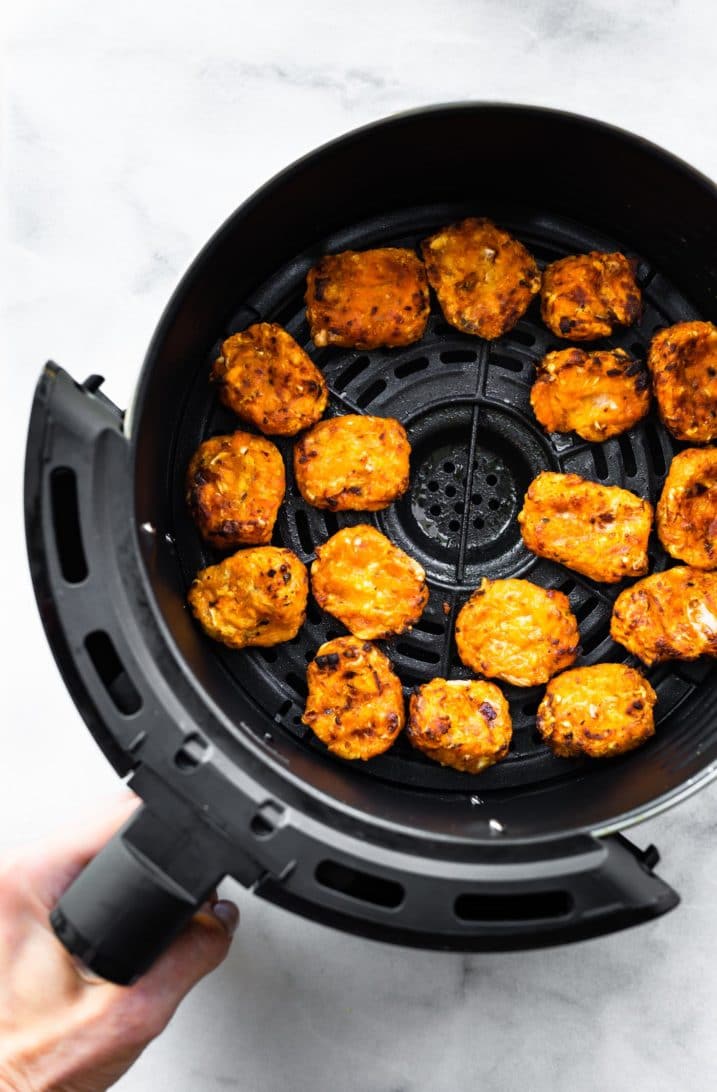 cooked vegan sweet potato tots in an air fryer basket