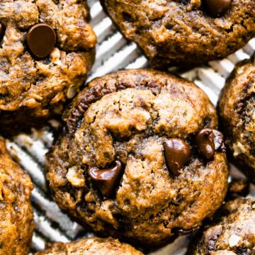 Overhead photo of breakfast cookies topped with chocolate chips on a sheet pan.