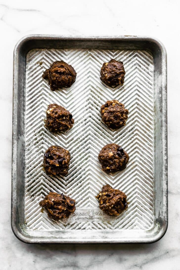 Gluten-free almond butter banana breakfast cookies batter on a silver baking sheet.