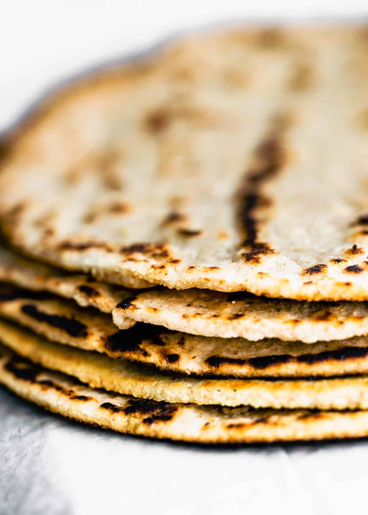 A stack of five cooked almond flour tortillas.