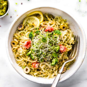 bowl full of spring pesto pasta made with arugula and broccoli