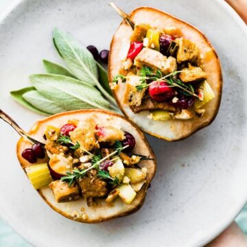 vegan stuffing in baked pears on white plate