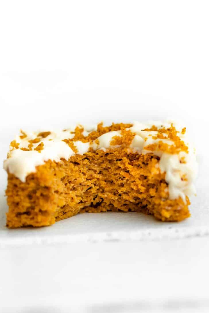 frosted gluten free pumpkin bar  with a bite taken out of it