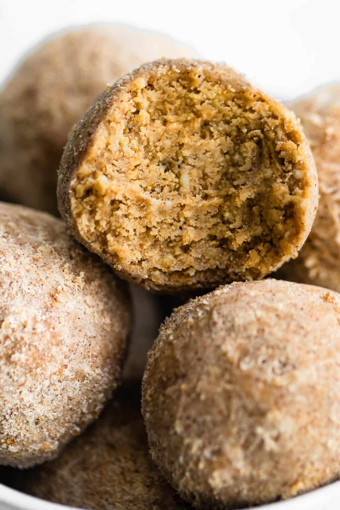 caramel snickerdoodle protein balls stacked in a white bowl