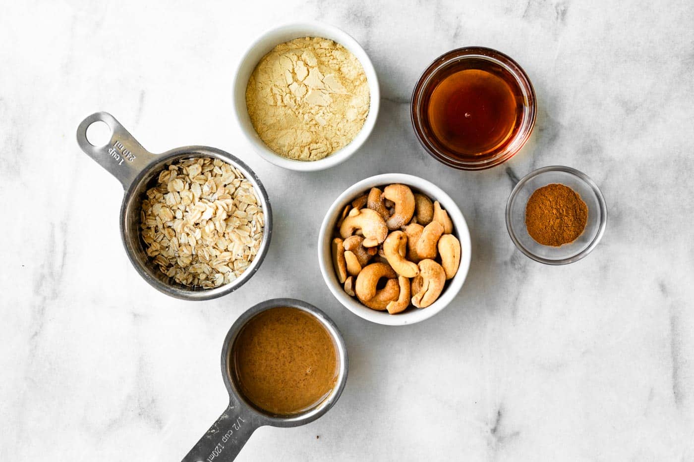ingredients in bowls and measuring cups to make no bake protein balls