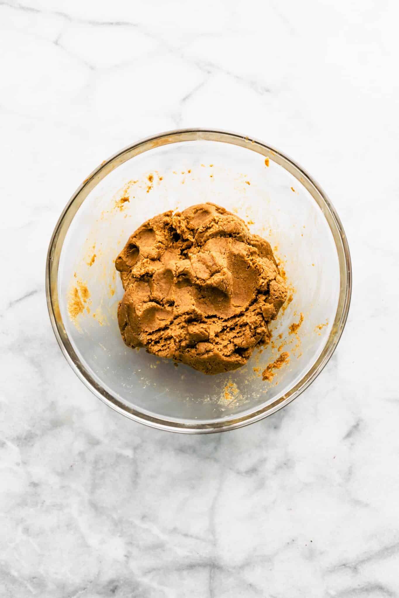 Almond flour protein dough in a glass bowl.