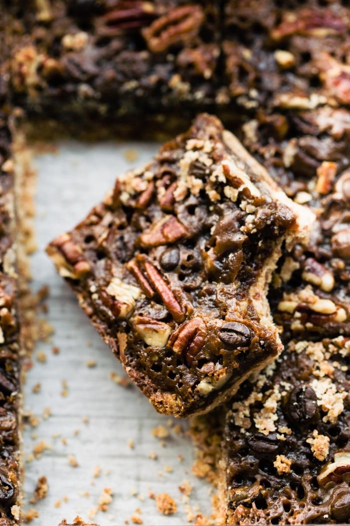 pan of pecan date bar cookies, one with bite removed