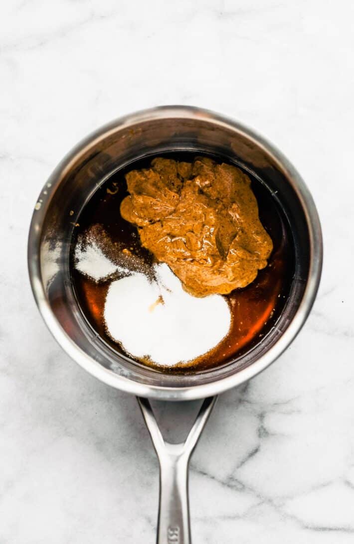 Nut butter, honey, and sugar in a sauce pan to make cereal bars.