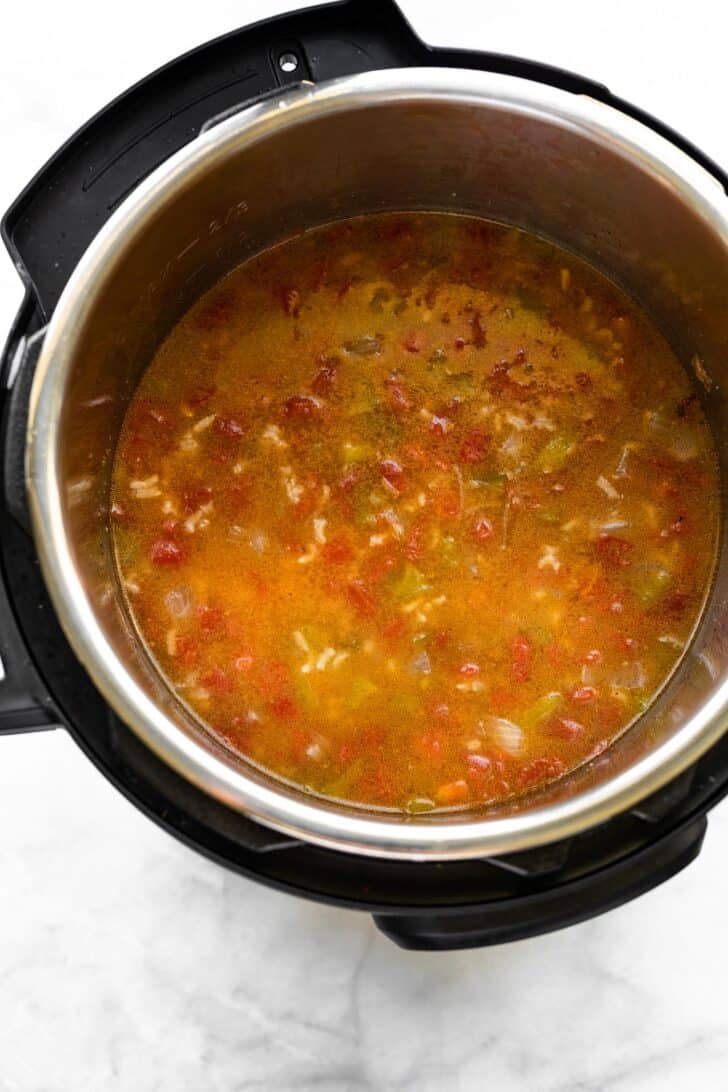 Cooked fajita steak soup with rice and diced tomatoes in an Instant Pot.