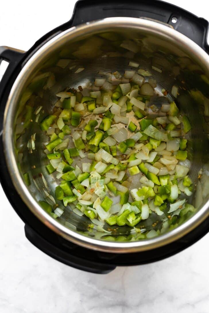 Sauteed diced onion, garlic, and green bell pepper in an Instant Pot.