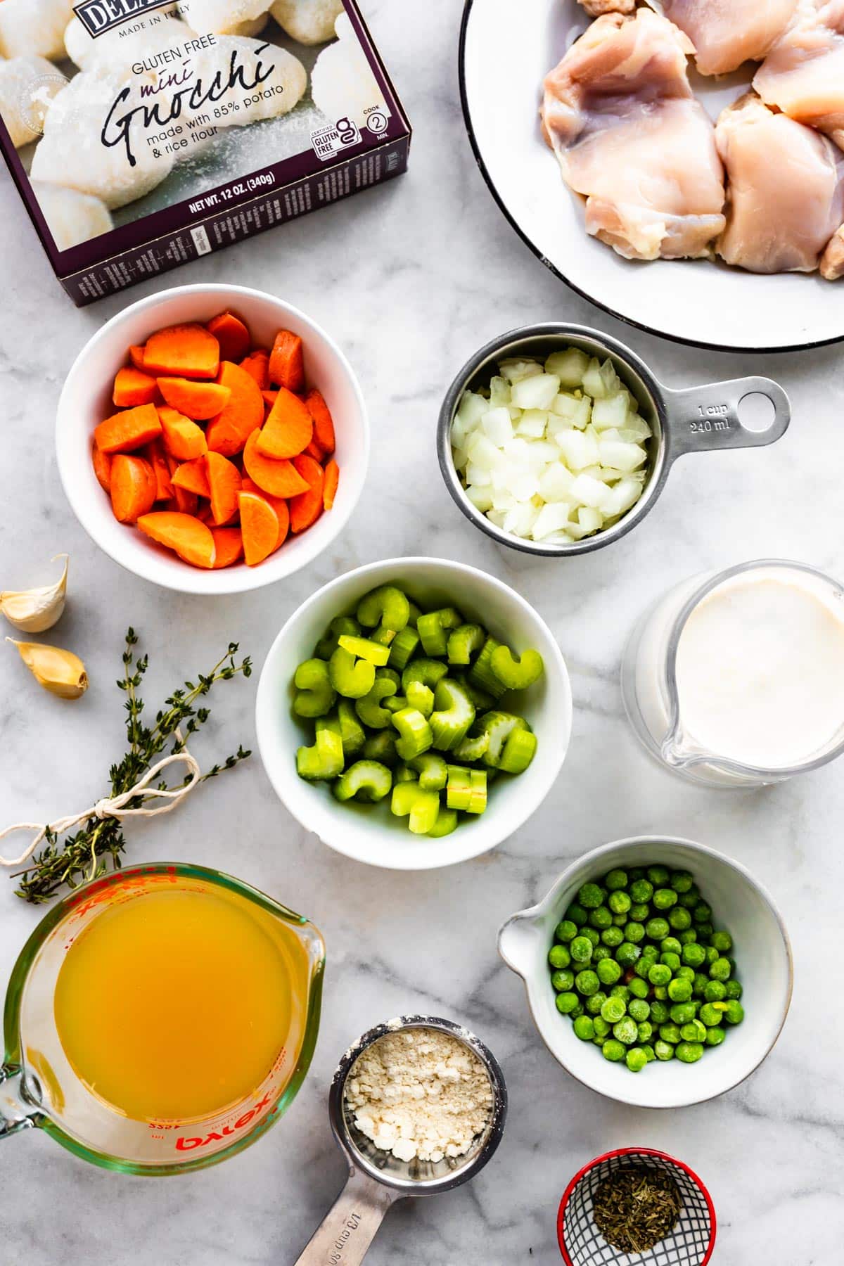 All the ingredients for creamy chicken and gnocchi like gluten free gnocchi and vegetables.