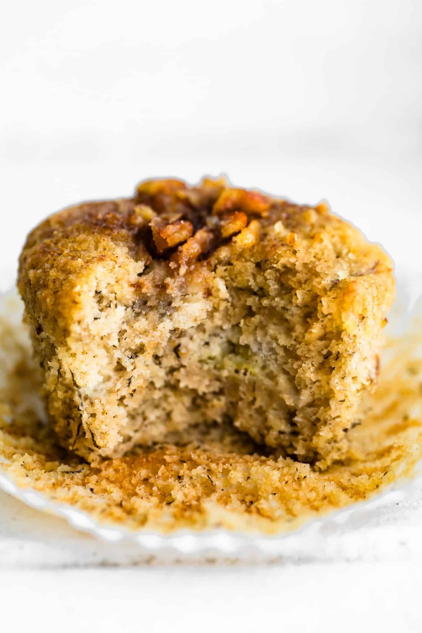 A bite taken out of a gluten free banana muffin.