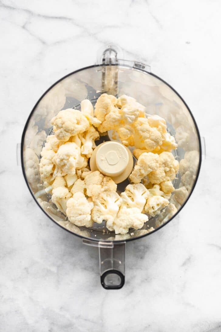 overhead photo of cauliflower floret in a food processor