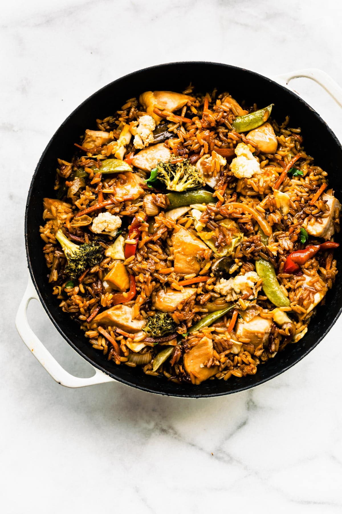 Overhead photo of teriyaki chicken casserole in a black pan ready to be baked.