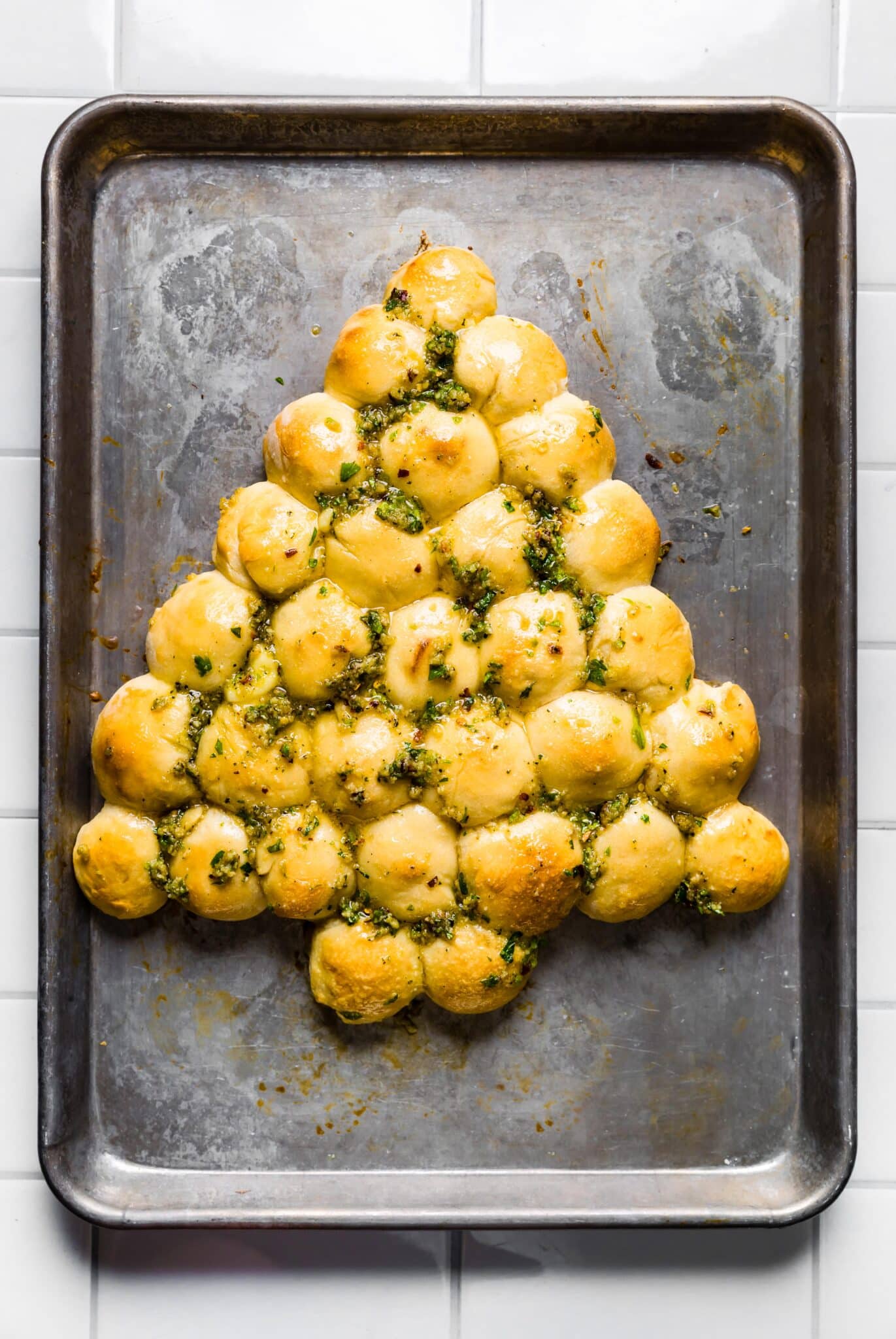 Overhead photo of a baked Christmas tree bread on a metal sheet pan.
