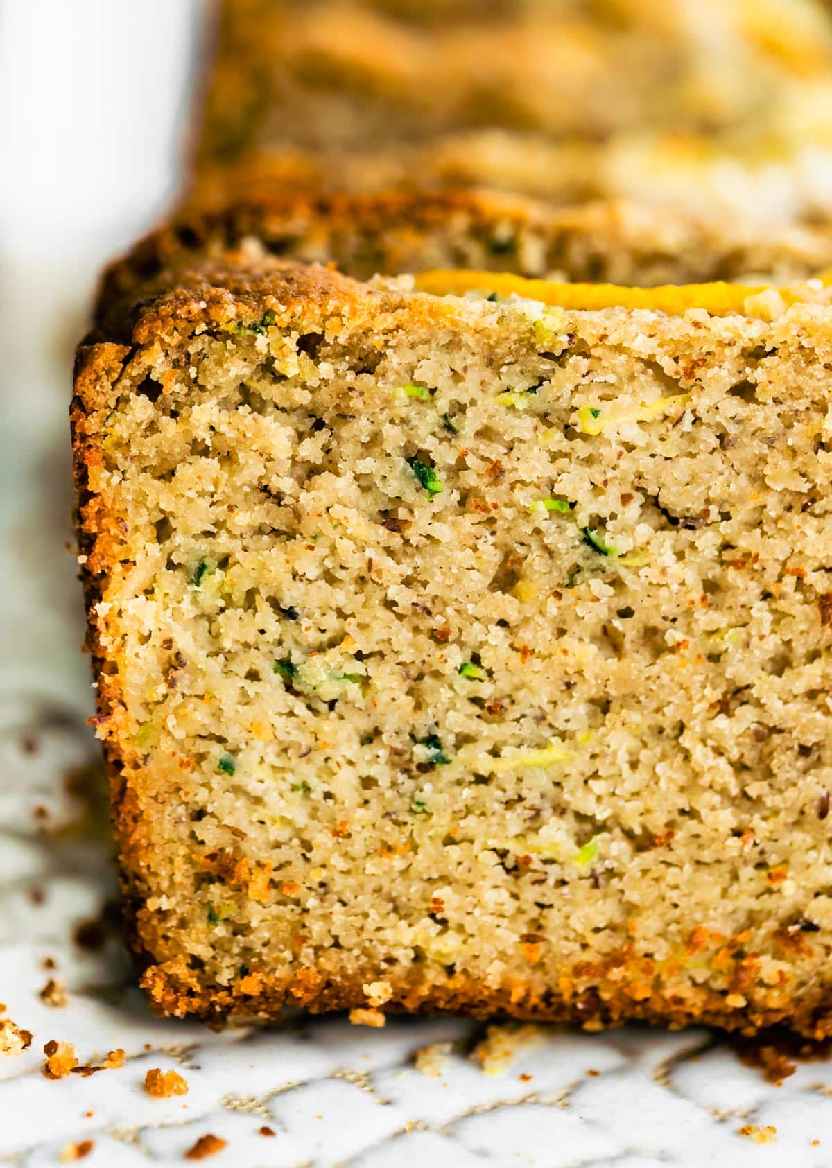 Close up image of a piece of gluten free lemon zucchini bread.