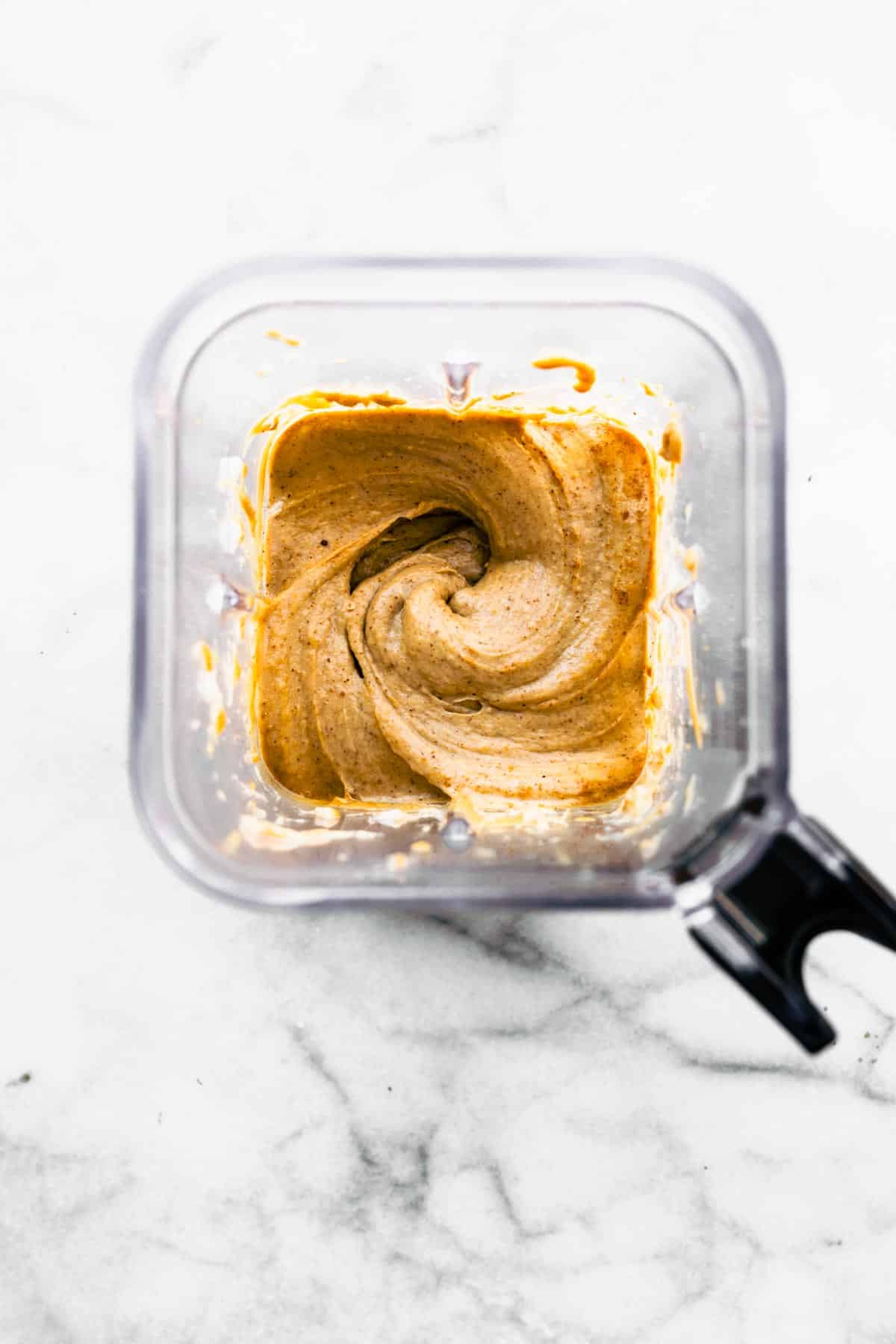 Peanut butter and bananas blended together in an blender.