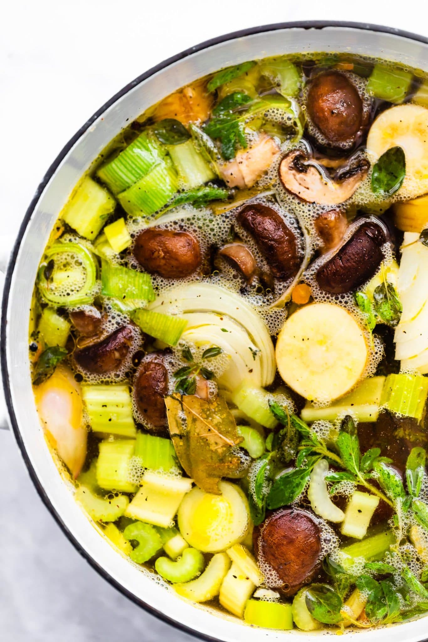chopped vegetables simmering in a dutch oven with water to create vegetable broth.