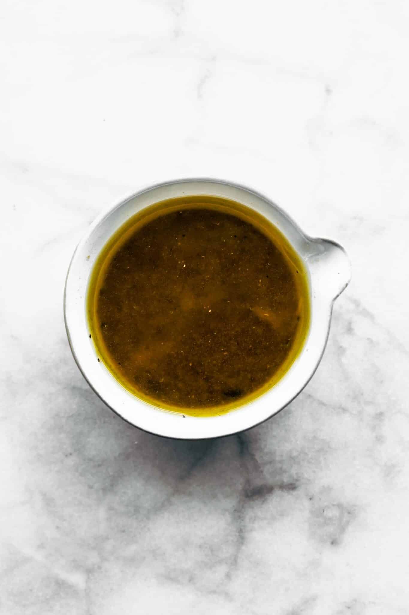 homemade vinaigrette in a small pourable bowl.