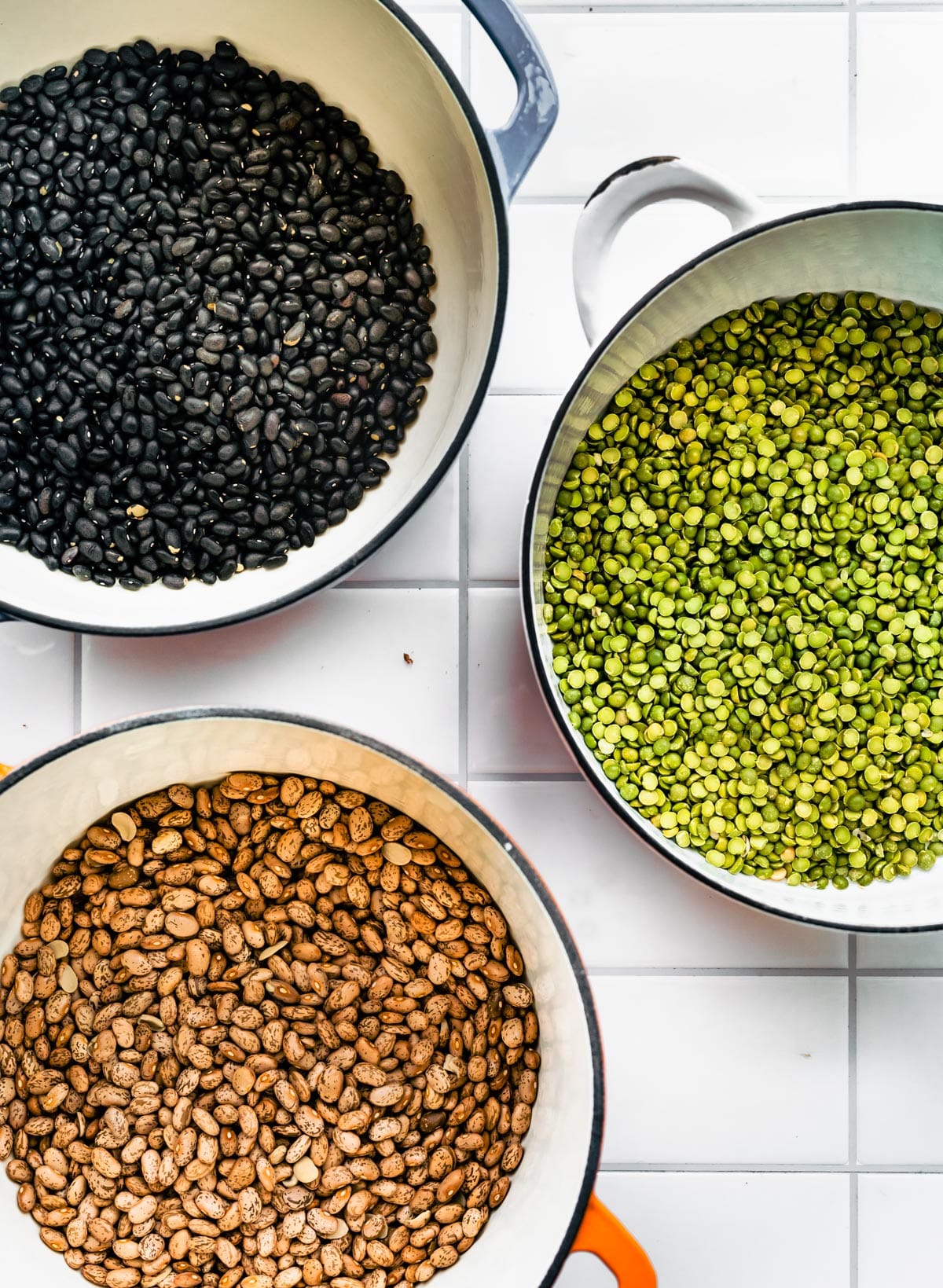 Overhead shot of a pot full of green split peas, kidney beans, and black beans.