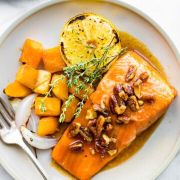 Up close photo of maple bourbon glazed salmon and veggies on a plate.