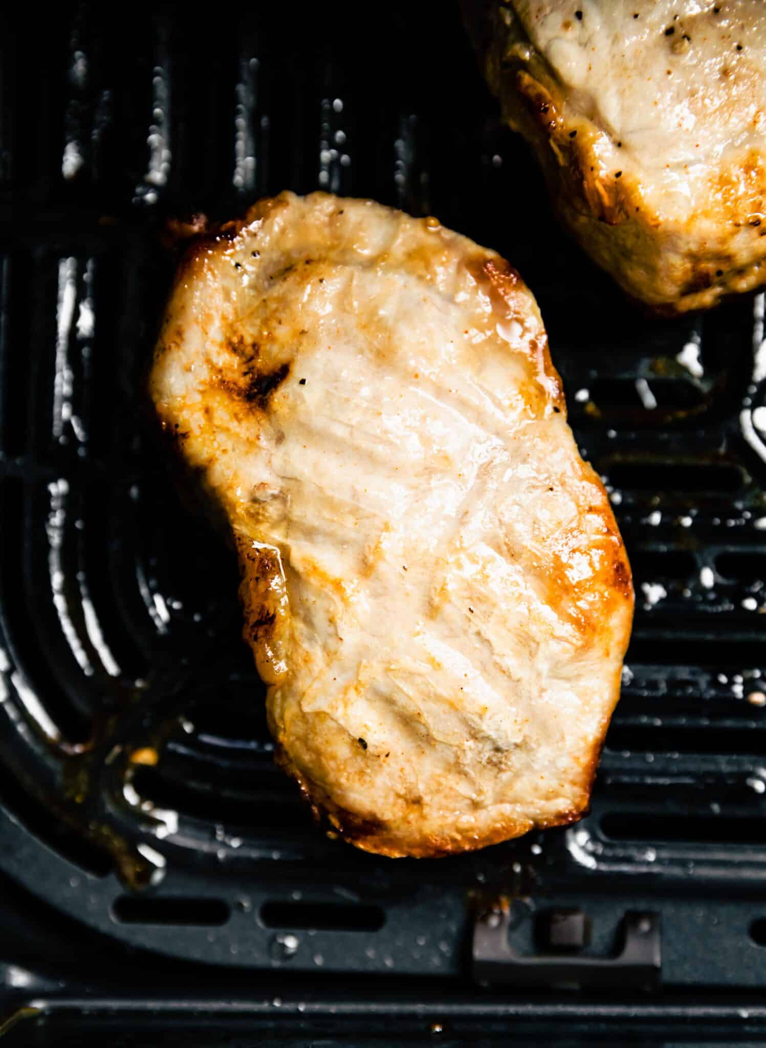 Up close photo of a maple bourbon glazed pork chop in the air fryer.