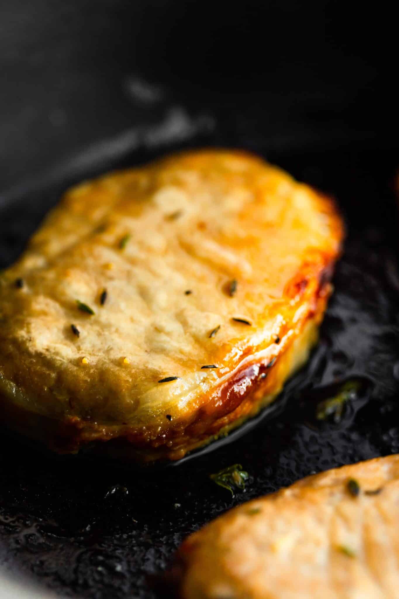 Up close view of an air fried boneless glazed pork chop in the air fryer.