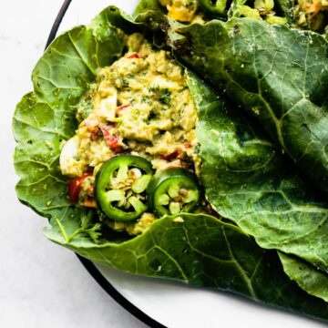 close up image of Mexican avocado egg salad wraps in collard greens