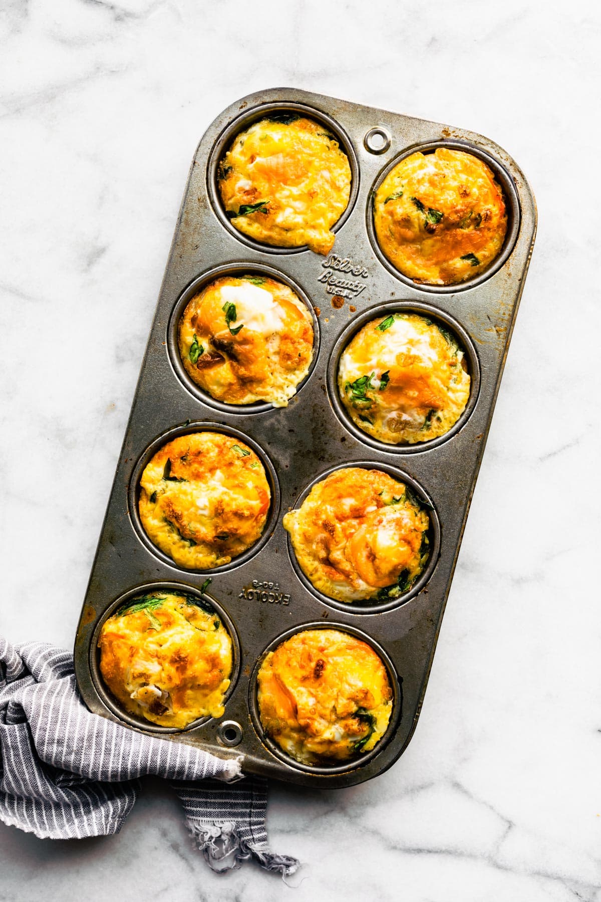 Cooked Frittata Muffins in a muffin pan.