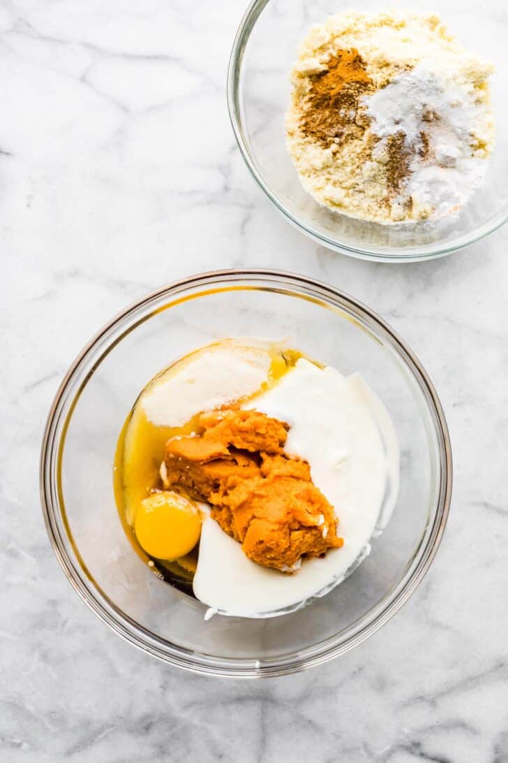 two bowls of batter , one dry ingredients, one wet ingredients for gluten free pumpkin bars. Overhead angle