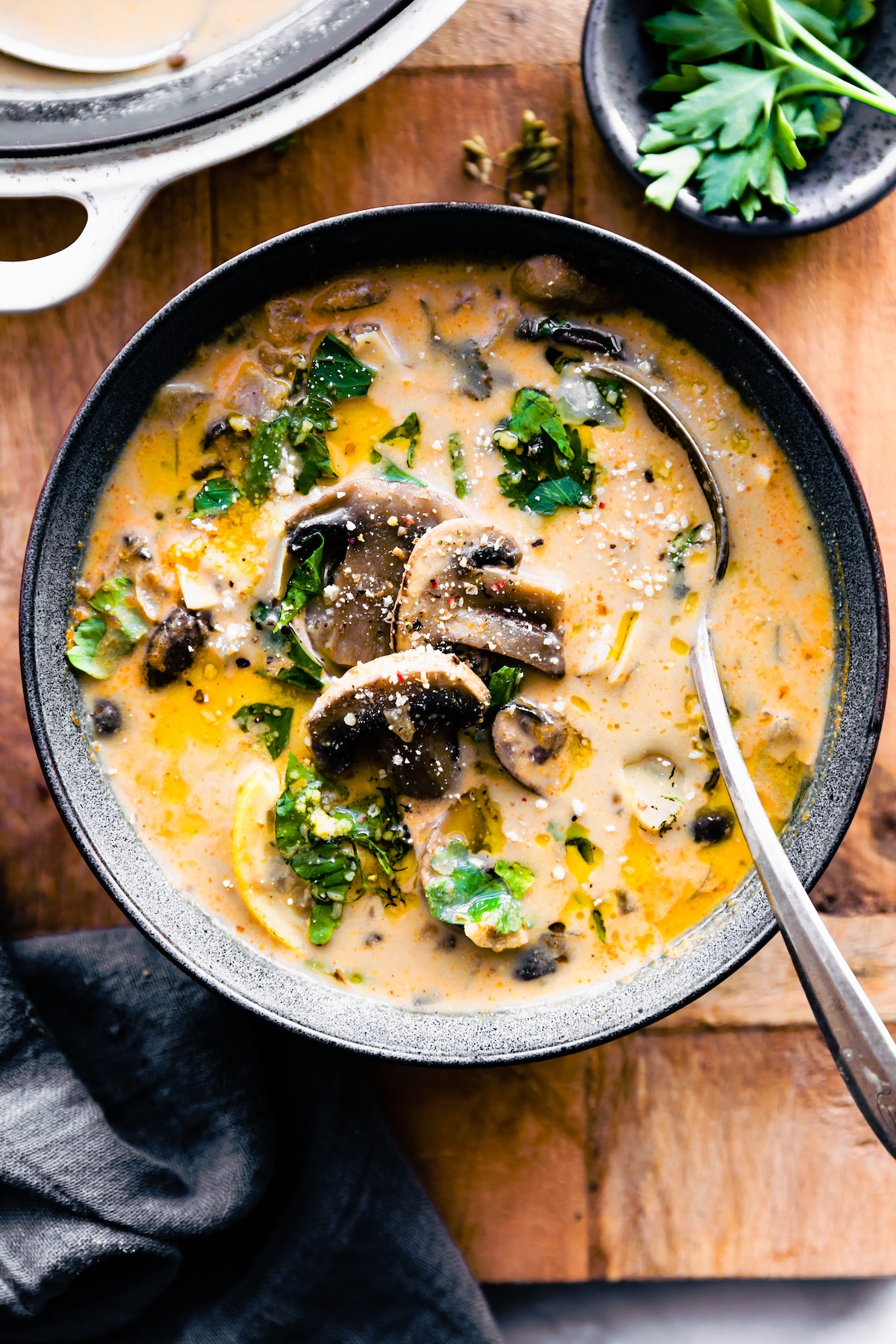 a bowl of creamy vegan mushroom soup with a spoon sticking out