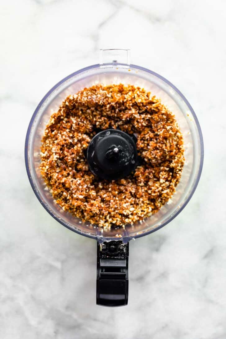 Cheesecake base being blended in a food processor.