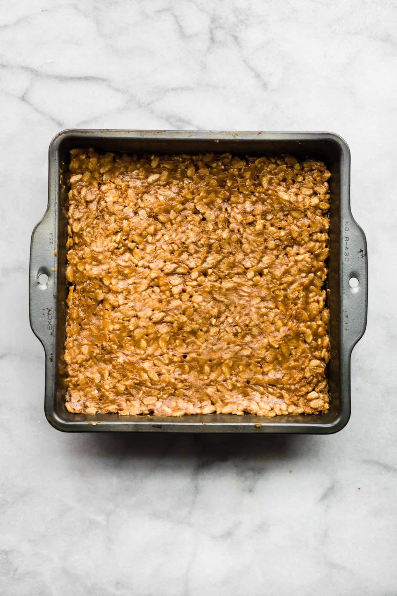 Overhead photo of a pan of crispy peanut butter protein bars.