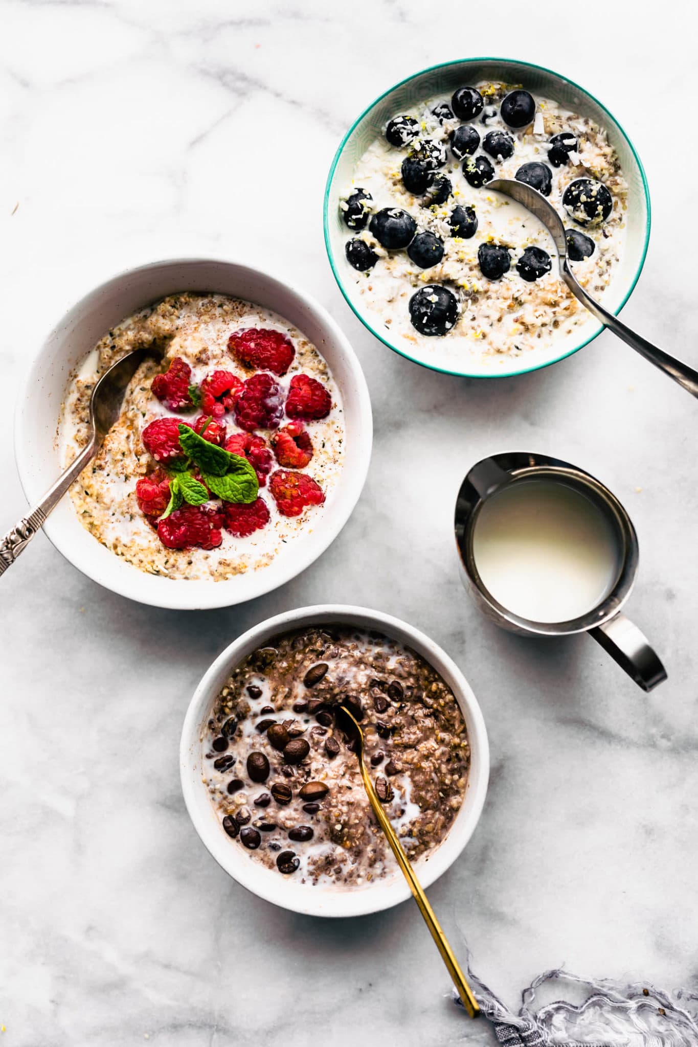 three bowls of n'oatmeal with difference toppings