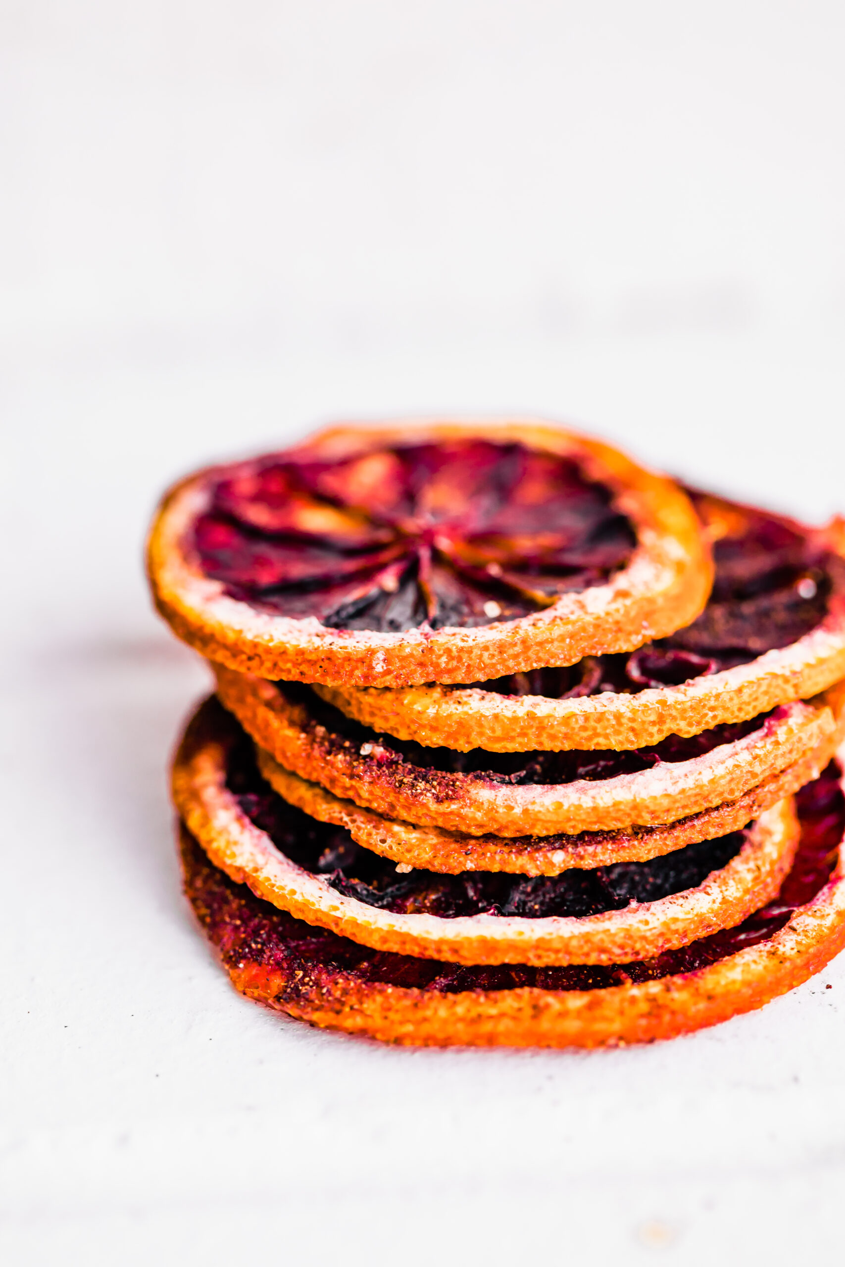 stack of dried orange slices on white background