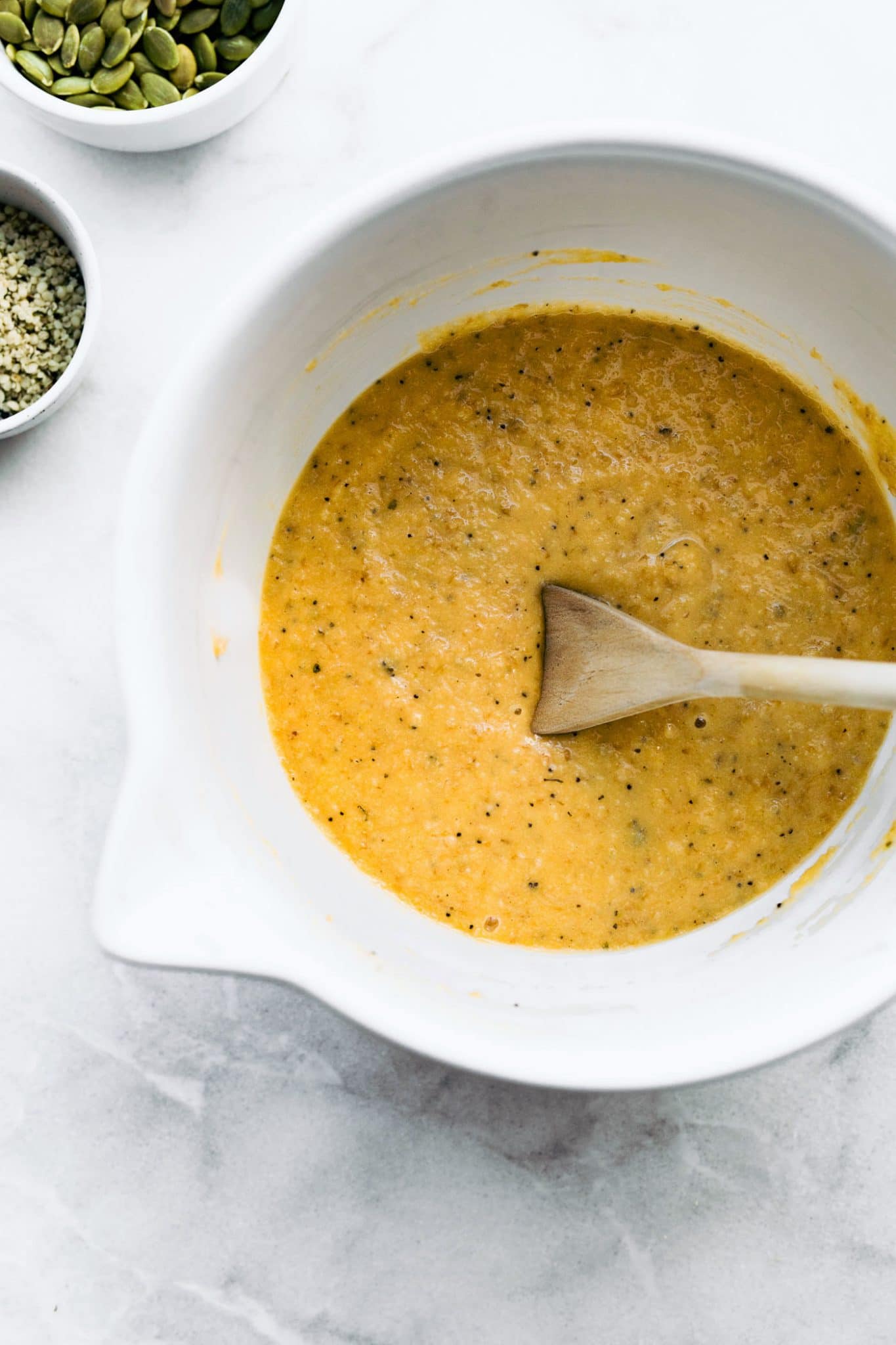 Overhead photo of grain free bread batter in a white mixing bowl.