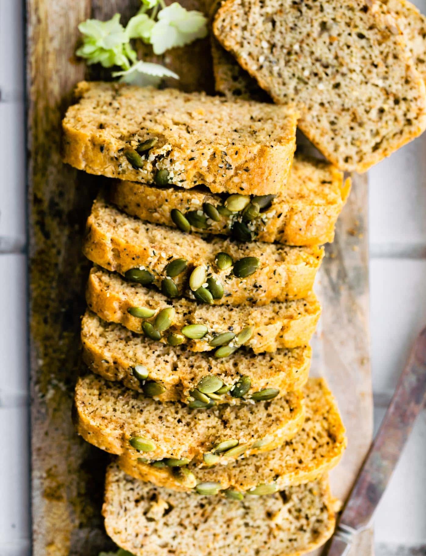 Overhead photo of sliced grain free paleo bread with pumpkin seeds on top.