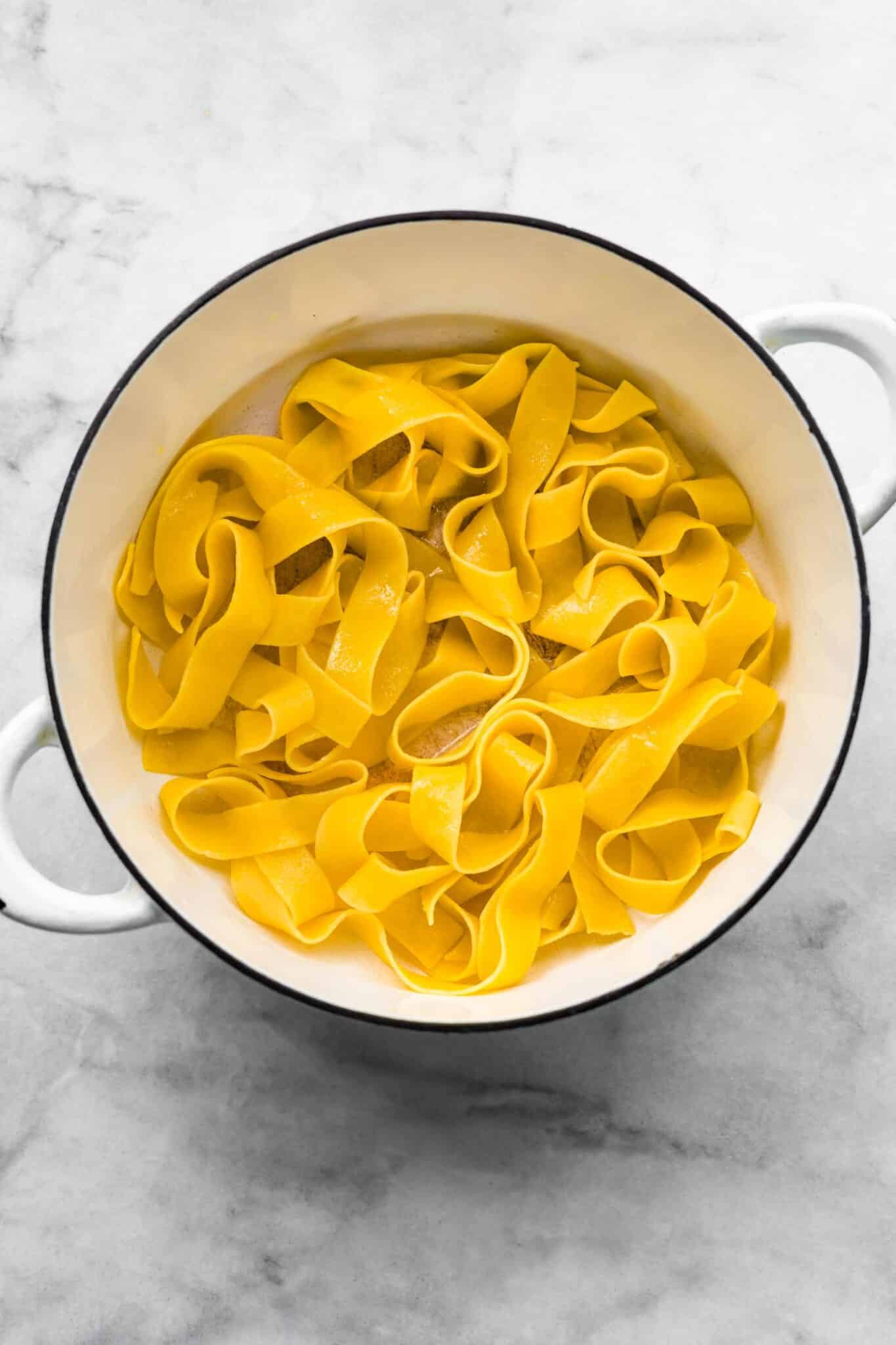 gluten-free pasta cooked and tossed in olive oil in a white pot