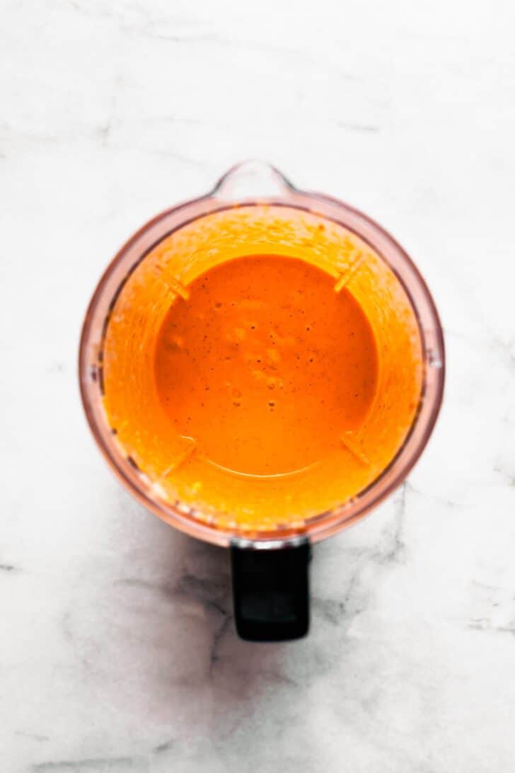 overhead photo of a blender of roasted red pepper sauce